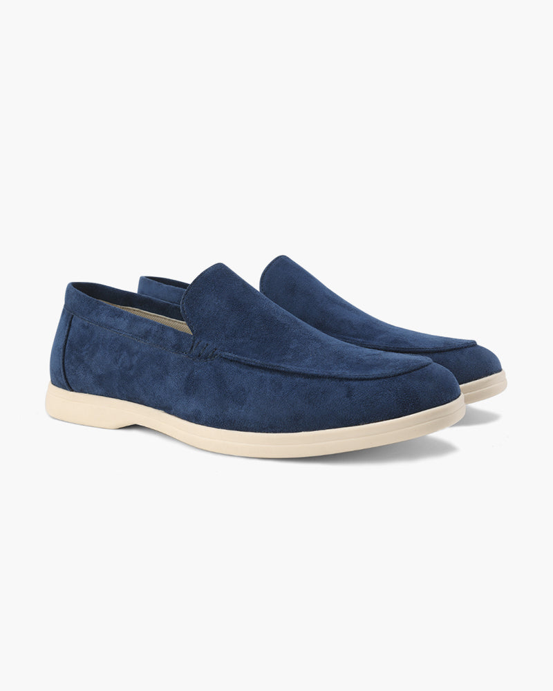 Pair of blue suede loafers on a white background