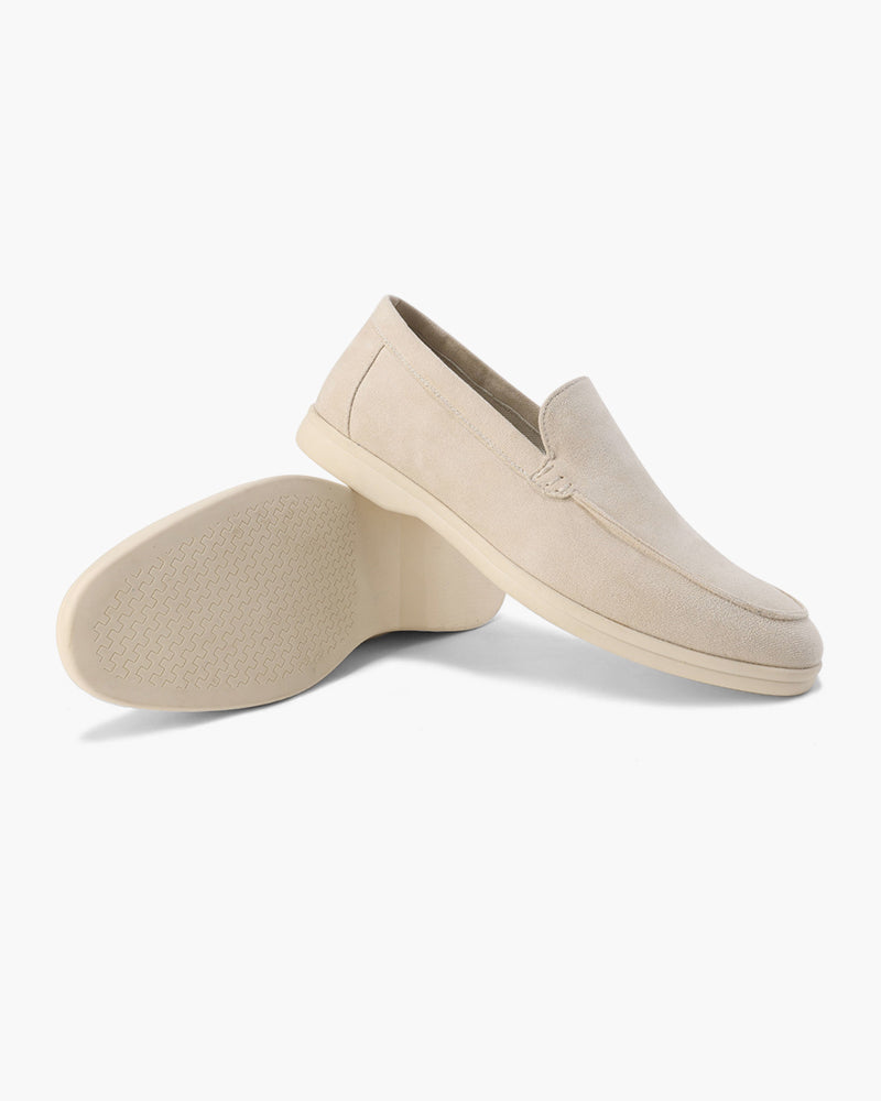 Pair of beige loafers on a white background
