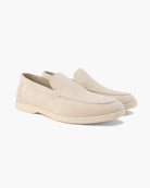 Pair of beige loafers on a white background