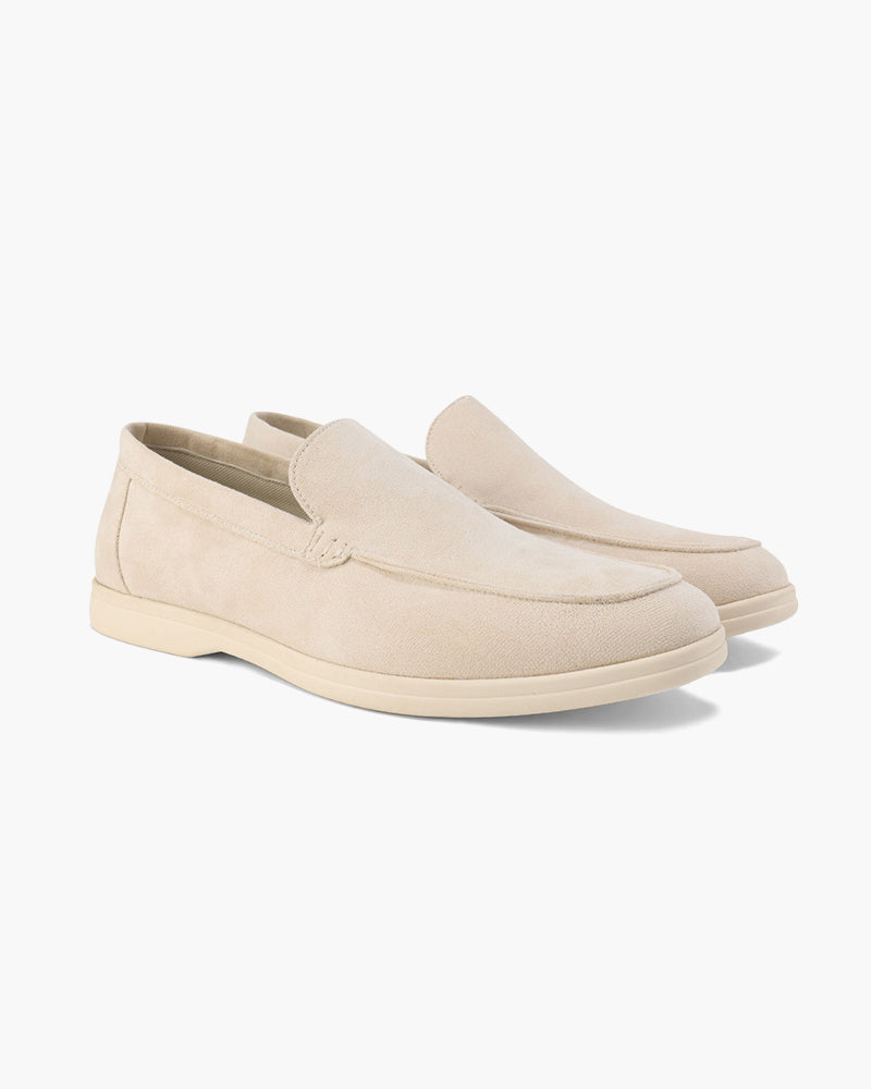 Pair of beige loafers on a white background