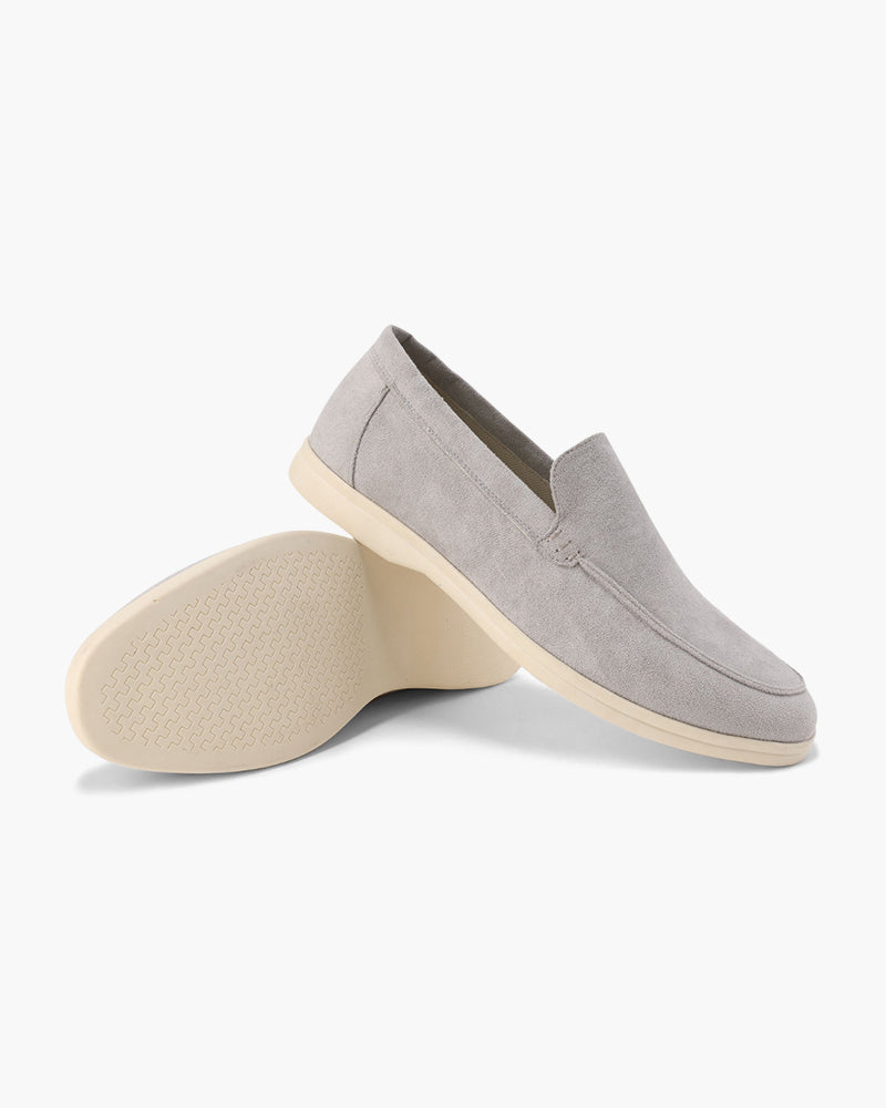 Gray loafers with beige soles on a white background