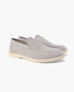 Pair of gray suede loafers on a white background