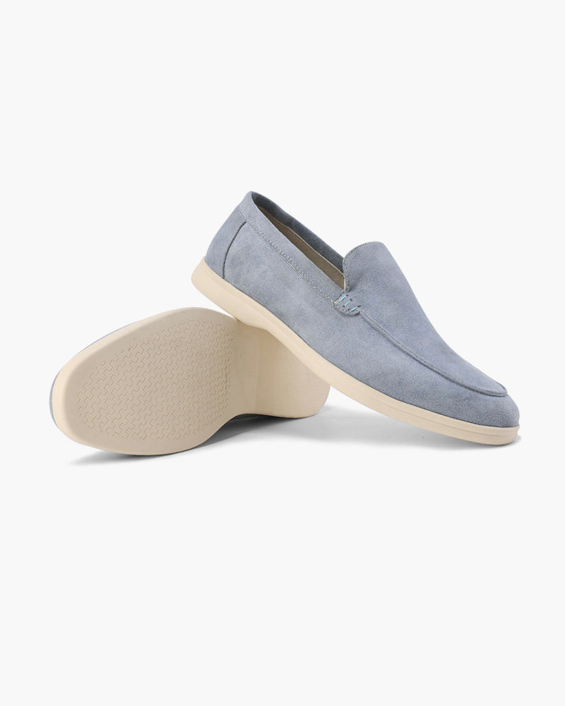 Gray suede loafer with beige sole on a white background