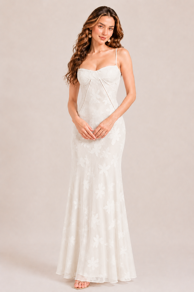 Woman wearing a white strapless dress against a plain background