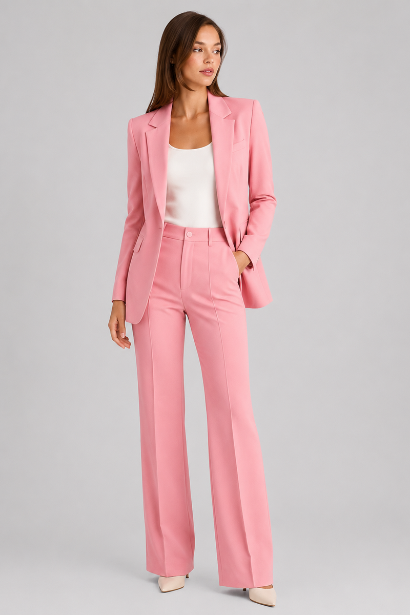 Woman wearing a pink suit with a white top on a gray background