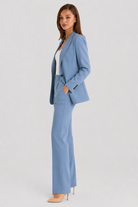 Woman wearing a light blue suit on a white background