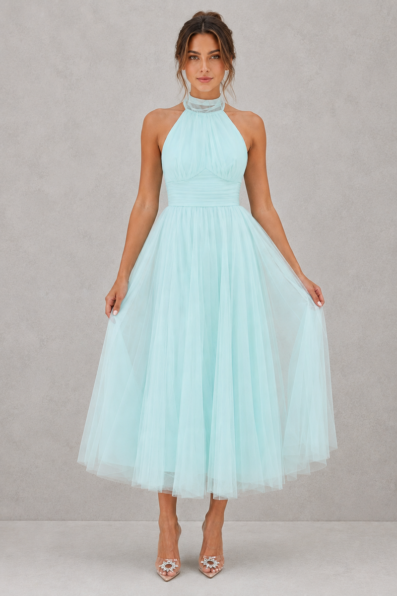 Woman wearing a light blue dress against a gray background