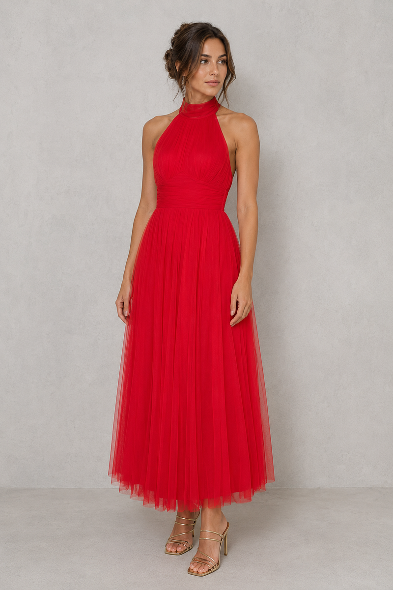 Woman wearing a red halter neck dress against a plain background