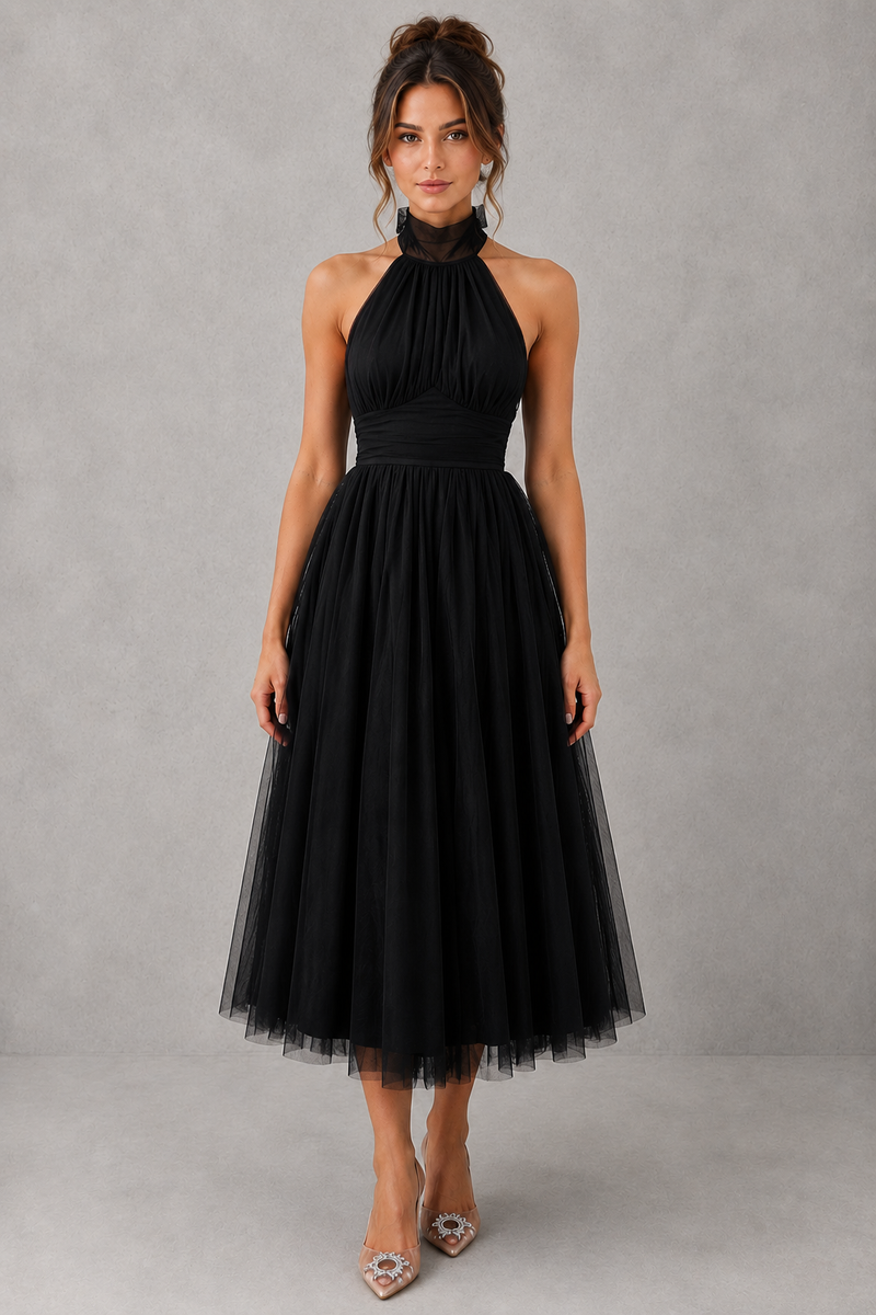 Woman wearing a black halter neck dress against a gray background