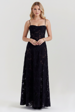 Woman wearing a black lace dress on a white background