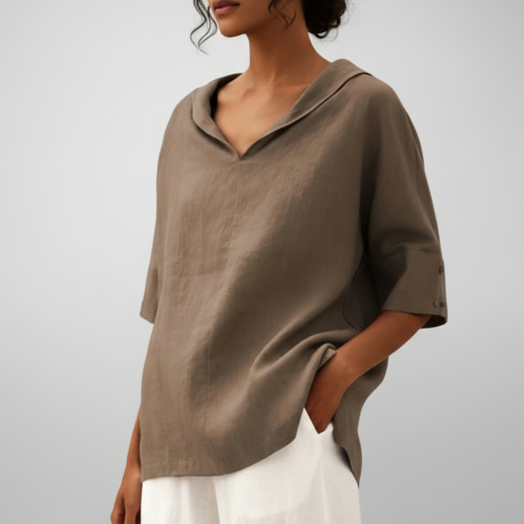 Person wearing a brown shirt with a plain background