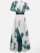 White dress with green floral pattern on a white background