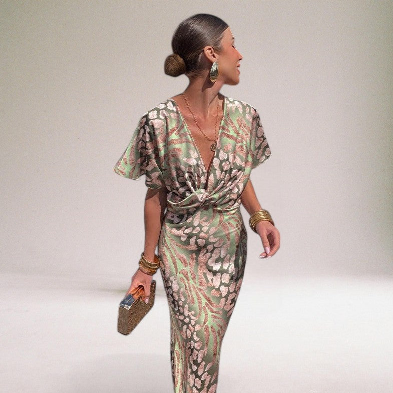 Woman wearing a patterned outfit against a plain background