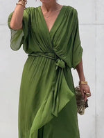 Green dress worn by a person against a white background