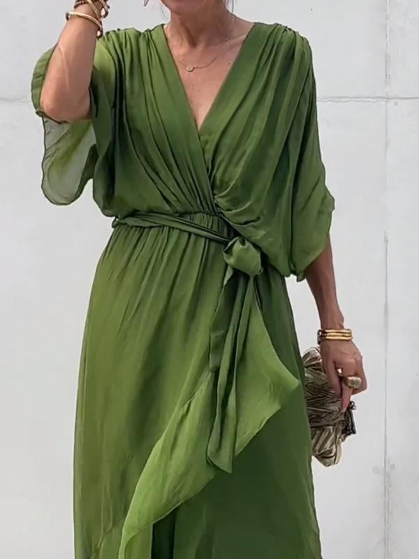 Green dress worn by a person against a white background