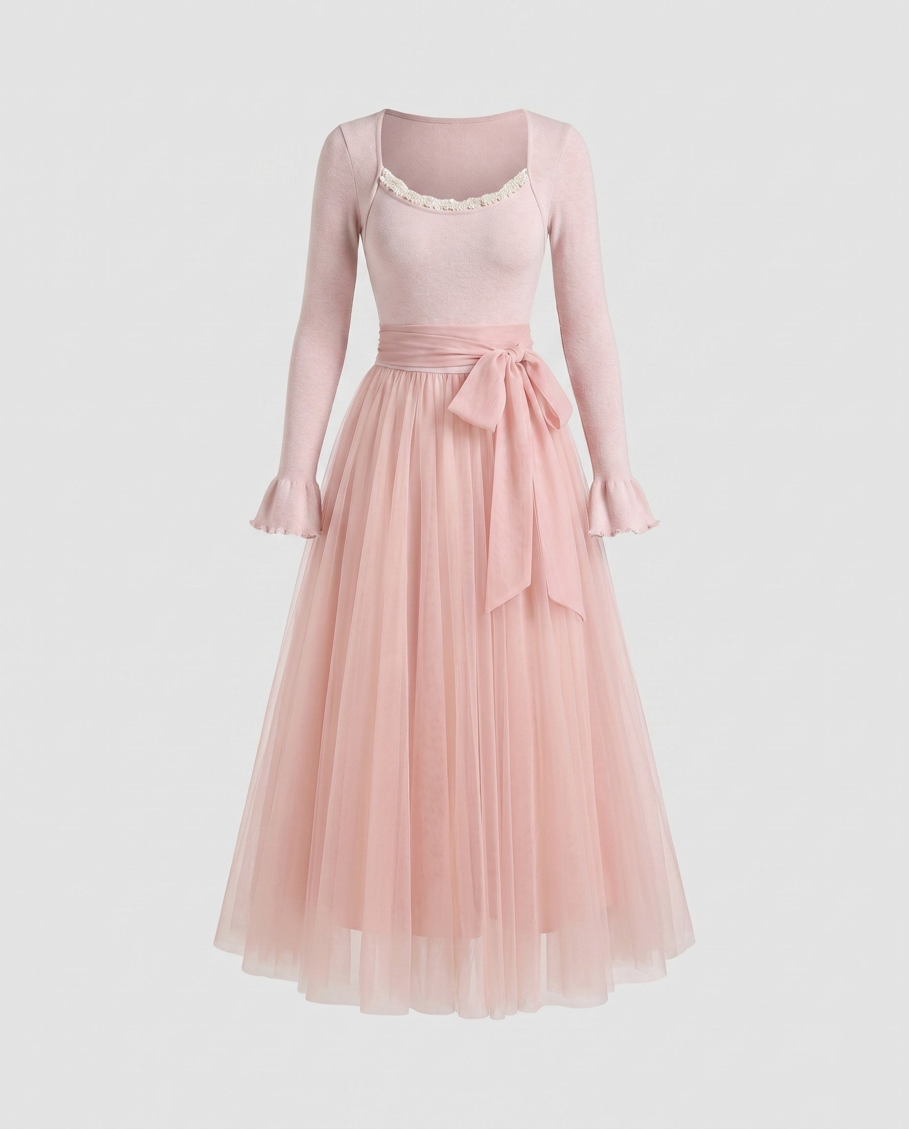 Pink dress with long sleeves on a light gray background
