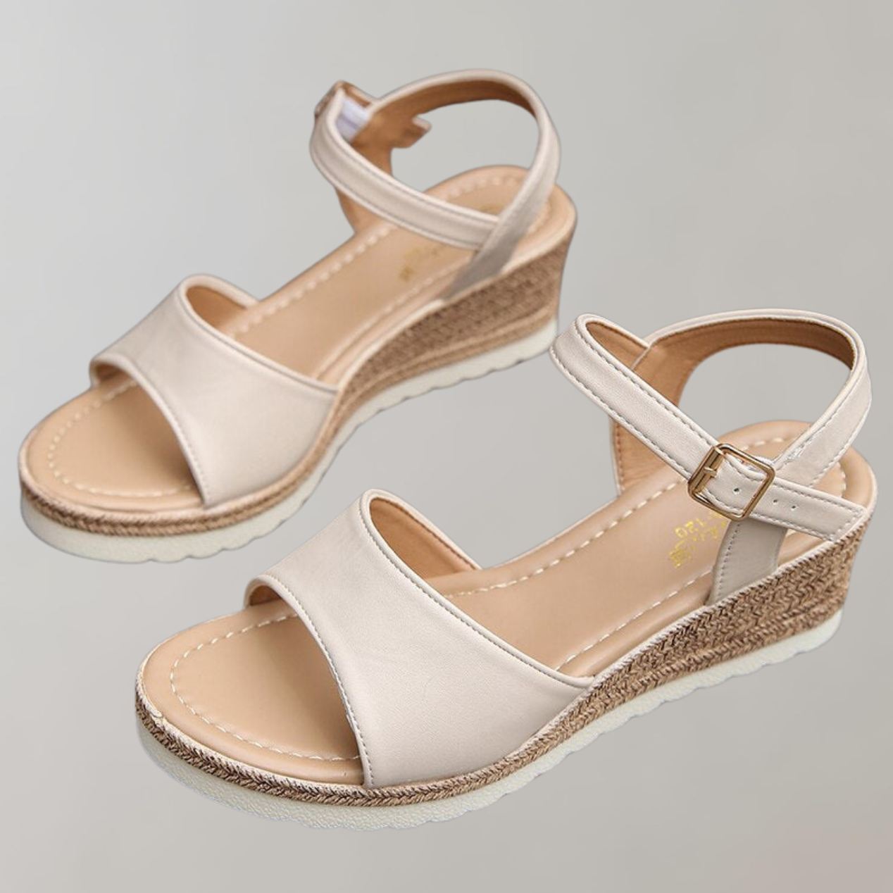 Pair of beige sandals with cork wedge sole on a light gray background