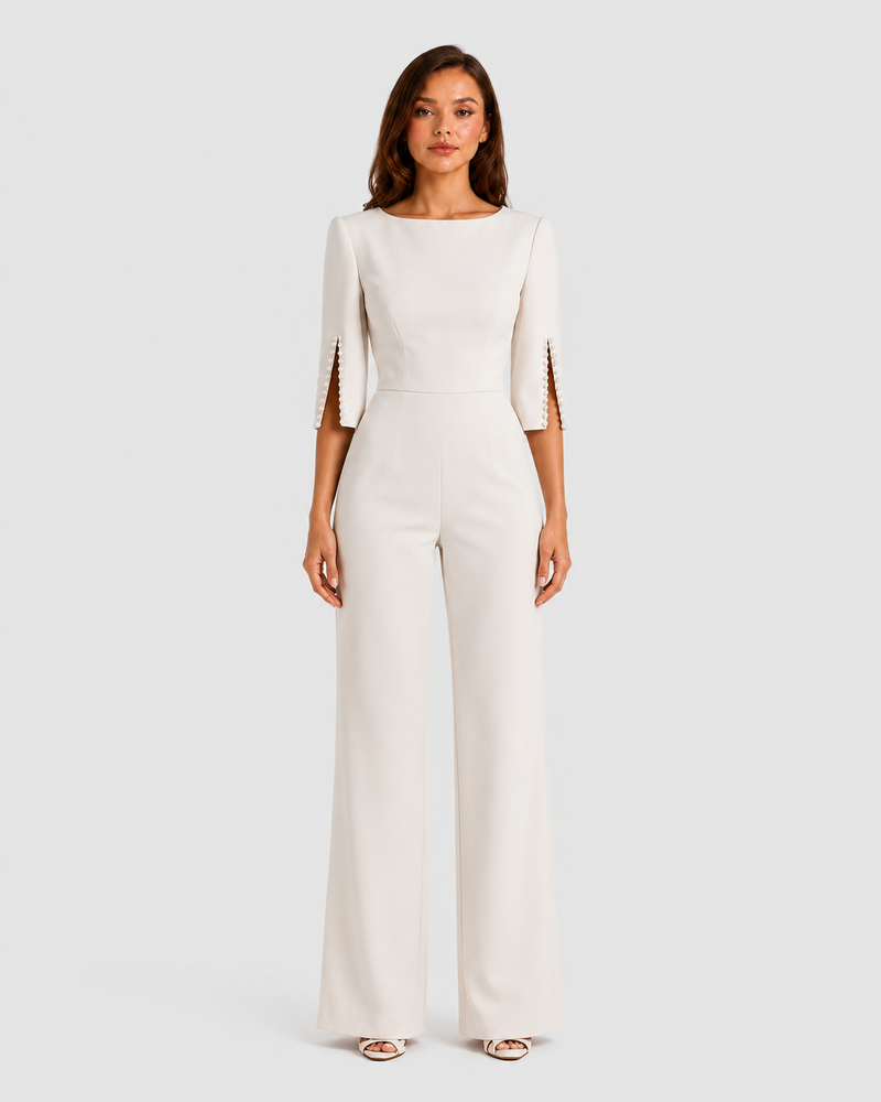Woman wearing a white jumpsuit on a plain background