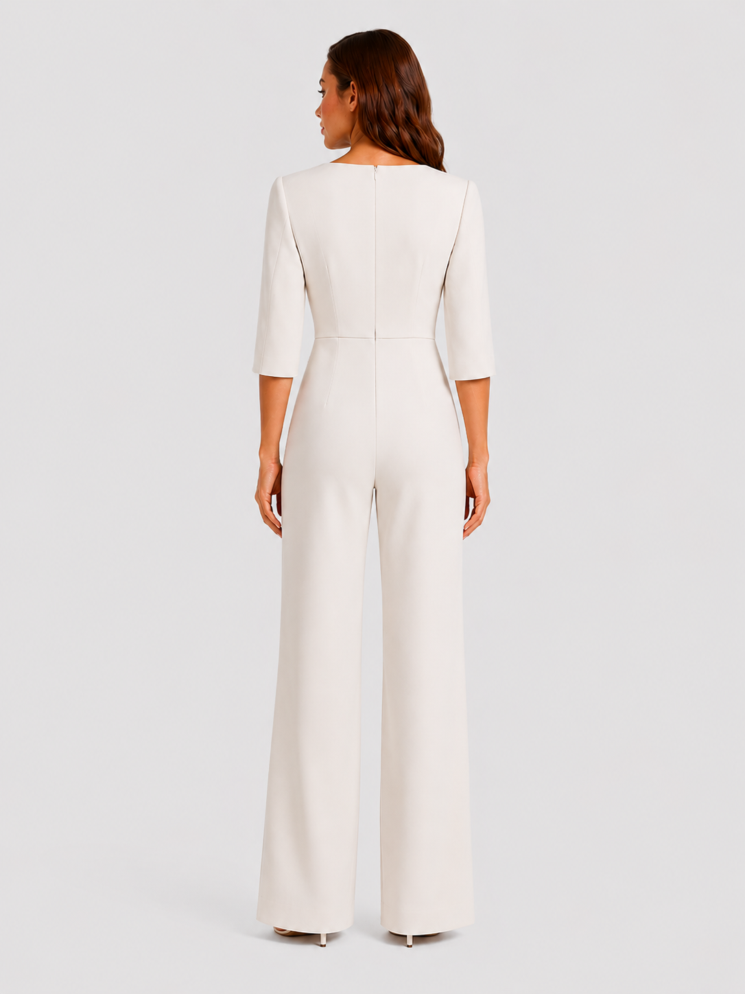 Woman wearing a white jumpsuit on a light gray background