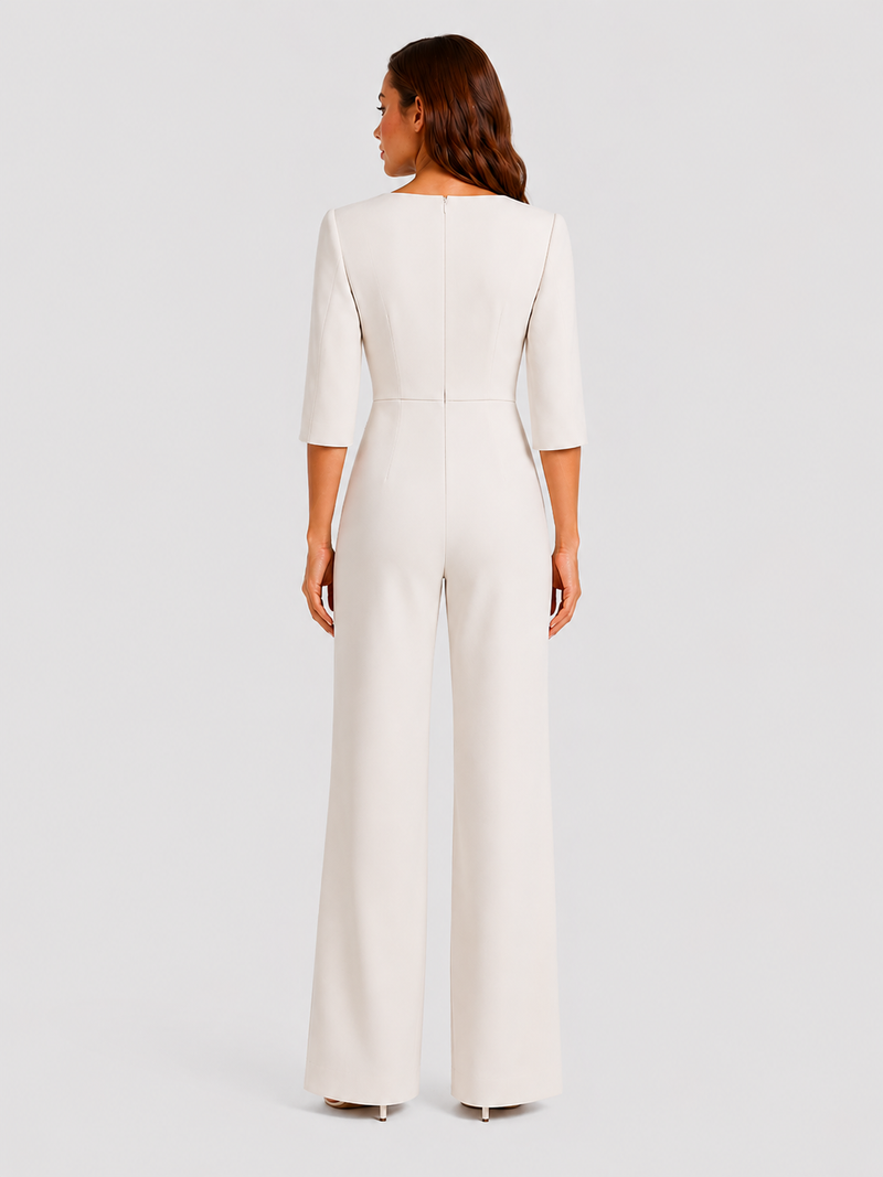 Woman wearing a white jumpsuit on a light gray background