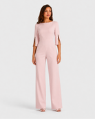 Woman wearing a light pink jumpsuit on a white background