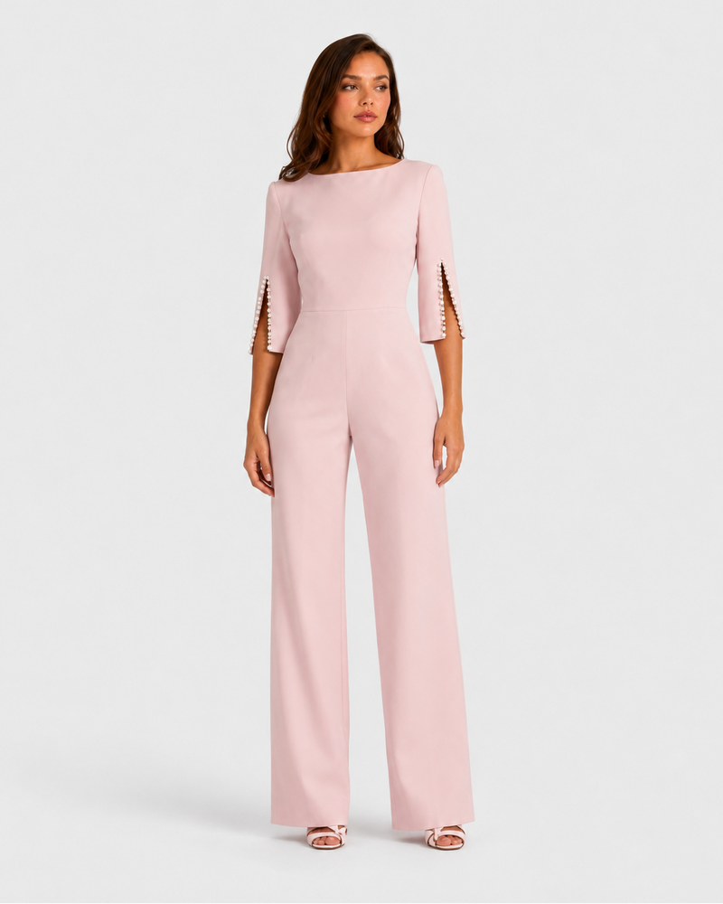 Woman wearing a light pink jumpsuit on a white background