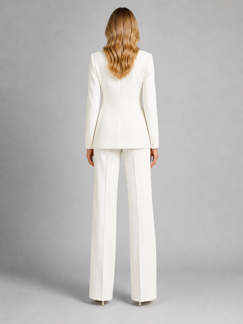 Woman wearing a white suit on a gray background