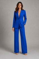 Woman wearing a blue suit against a gray background