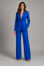 Woman wearing a blue suit against a gray background