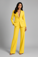 Woman wearing a bright yellow suit against a gray background