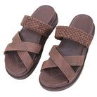 Pair of brown sandals with woven straps on a white background