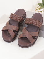 Pair of brown sandals with woven straps on a white surface.
